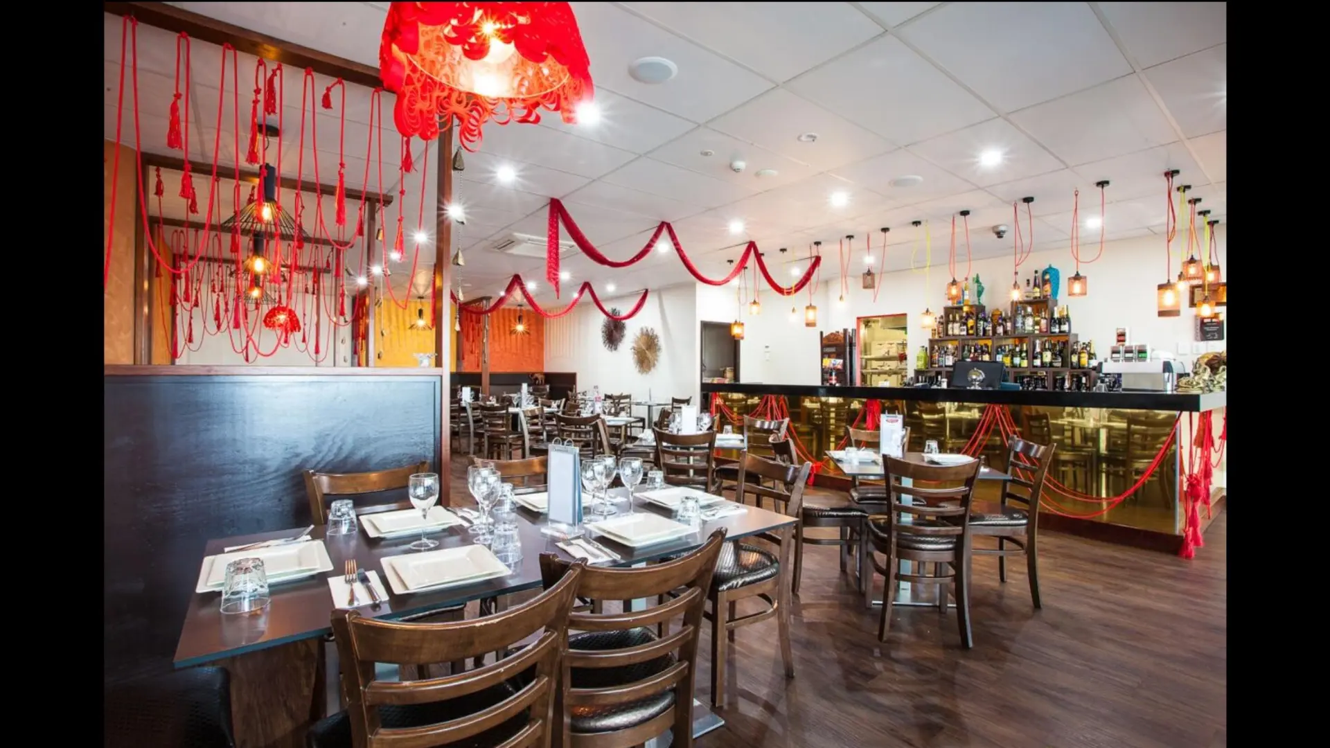 Inside Indian Brothers Restaurant, set tables and warm hanging lights